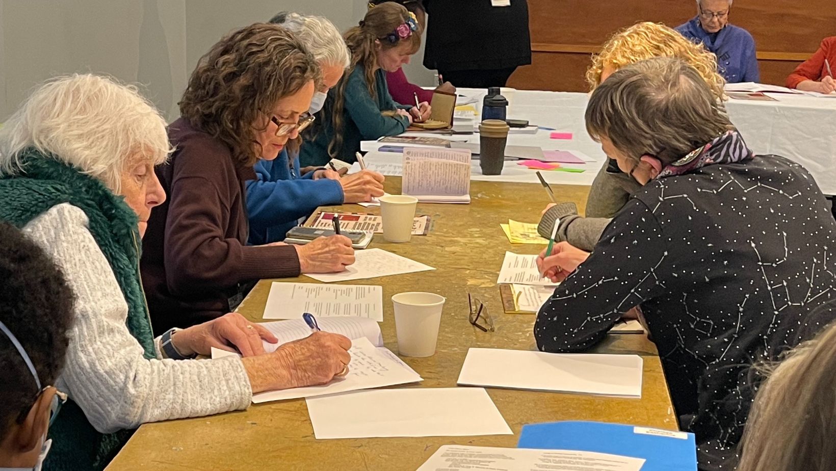 Attendees do some writing during María Luisa Arroyo Cruzado's 'Naming Our Roots' workshop