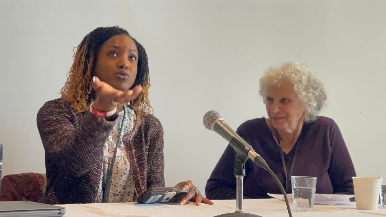 Poet, Lyrical Faith speaks during the Beyond the Book session while moderator Julie Schlack looks on